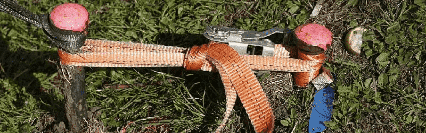 Tensioning strap on industrial cargo